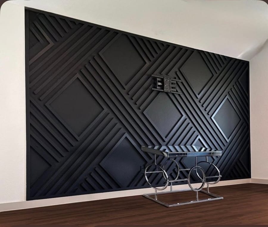 Black geometric accent wall with a diamond inlay pattern