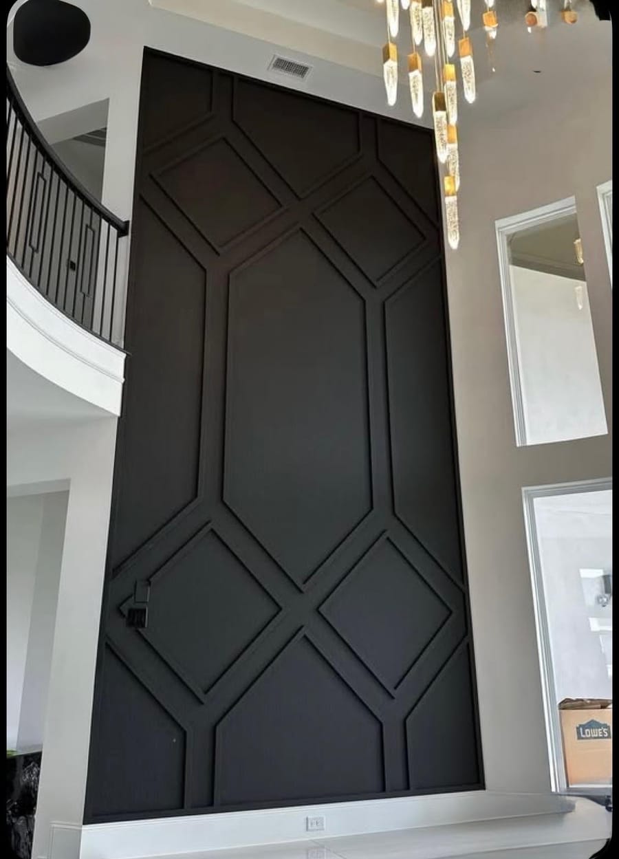 Black fluted diamond accent wall in a two story entry