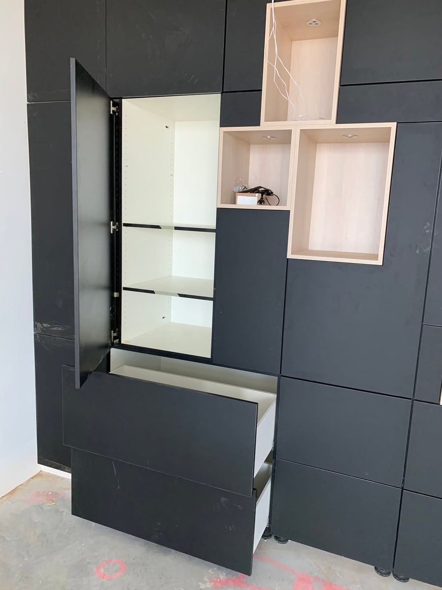 Dark cabinetry run with a lit glass display cabinet