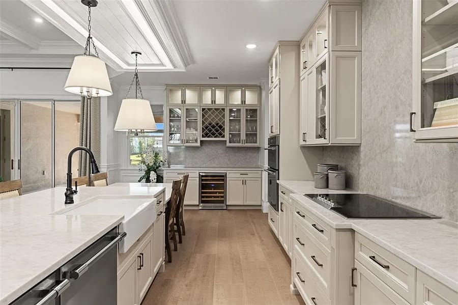 Kitchen with built-in wine fridge cabinetry beneath a coffered ceiling