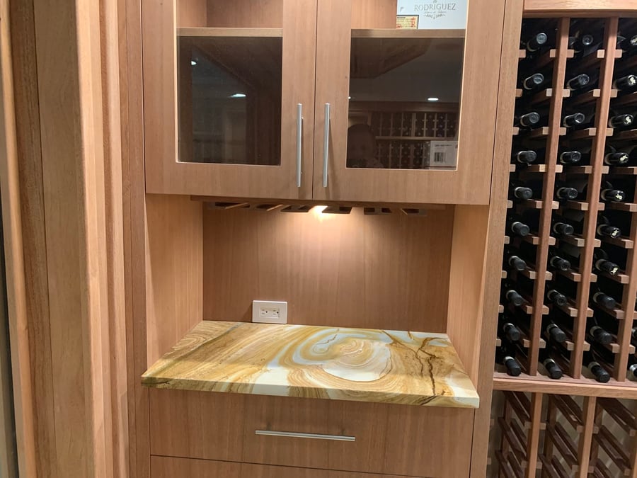 Wine cellar cabinetry with a stone counter and bottle racking
