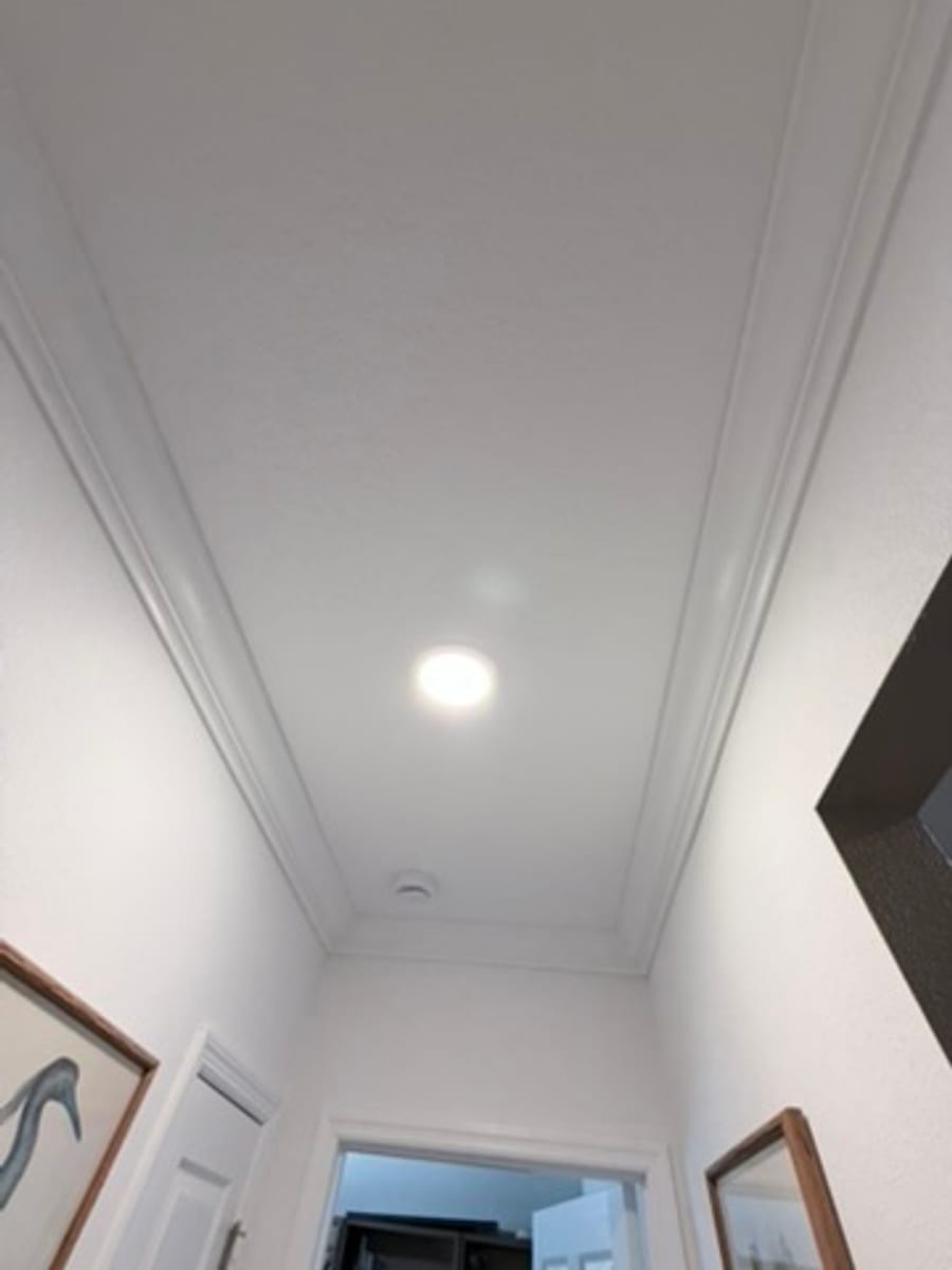 Crown molding running down a hallway ceiling, straight on view